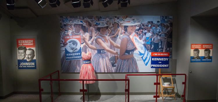 a display with a photo and one of jackie kennedy's dresses at the JFK presidential library and museum