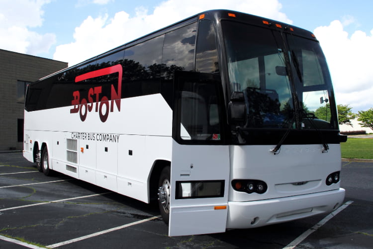 a Boston Charter Bus Company branded charter bus parks with the door open
